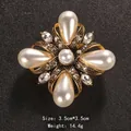 Vintage gold brooch with teardrop pearls and crystals on black textured background - Classical Cross Flower Pearl Style (XD10462)