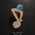 Elegant musical note brooch with sparkling clear and blue rhinestones in gold tone. - Gold / Blue Floral