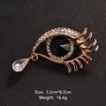 Elegant gold-toned eye shaped brooch with crystals and a teardrop pendant for suits - 3.2cm*6.3cm / Gold Eye with Black Pupil