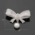 Elegant silver-toned bow brooch encrusted with rhinestones and a white pearl drop - Bowknot Pearl Style (XD7706-2)