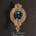 Ornate vintage gold-tone brooch with large teal oval crystal and clear rhinestones - Oval Teal Crystal Style (XD9080)