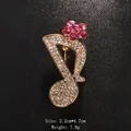 Elegant musical note brooch featured with pink and clear rhinestones on black texture - Gold/Pink Flower