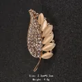Elegant leaf-shaped brooch featuring cat's eye stones and shimmering crystals for women - Leaf Pin (XD9171)