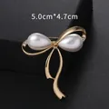 Elegant gold-tone bow-shaped brooch featuring white pearls and rhinestones, 5.0cm x 4.7cm - Bowknot Style (XD9366) / Gold
