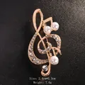 Musical note brooch with white pearls and sparkling rhinestones in a gold finish. - Gold/Hollow Pearl