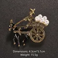 Vintage gold-tone carriage brooch featuring black enamel details and white pearls - Classical Carriage Style (XD8550)