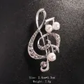 Silver treble clef music note brooch adorned with sparkling rhinestones and white pearls - Silver/Hollow Pearl