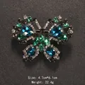 Butterfly brooch with vibrant blue and green teardrop crystals on black background - Blue-Green Inlaid Butterfly Style (XD10507)