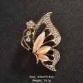 Elegant butterfly brooch with cat's eye stones and sparkling rhinestones in gold finish - Butterfly Floral Decoration (XD5686)
