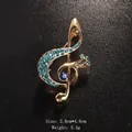 Elegant gold-tone musical note brooch adorned with sparkling blue rhinestones for suits - Gold/Blue Rhinestone