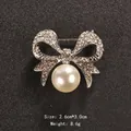 Elegant silver-tone bow brooch featuring sparkling rhinestones and a large white pearl accent - Silver Bowknot Hanging Pearl Style (XD6408-2)