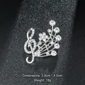Silver-colored treble clef brooch with rhinestones in SKU display - Treble Clef Shape (XD9119) / Silver