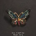 Ornate butterfly brooch featuring vibrant multi-colored rhinestones on a textured dark background - Colorful Rhinestone Butterfly Brooch (XD8537-02)
