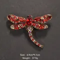 Exquisite vintage dragonfly brooch with red rhinestones and crystals on a dark background - Retro Red Rhinestone Dragonfly Style (XD8295-1)