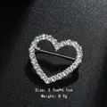 Elegant heart-shaped rhinestone brooch pin in silver finish for suit or dress accessories - Hollow Heart Style (XD8984) / Silver