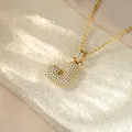 Macro detail view of a shiny iced out gold-plated letter J pendant hip-hop necklace - Letter J / Champagne Gold