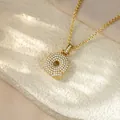Close-up of gold-plated hip-hop pendant necklace with sparkling pave letter Q pendant - Letter Q / Champagne Gold