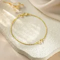 Detailed close-up of a gold-plated titanium steel bracelet featuring a letter S charm - Letter S Style / Gold