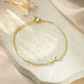 Detailed view of a gold titanium steel bracelet featuring an elegant letter Y pendant. - Letter Y Style / Gold