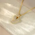 Close-up of a gold-toned hip-hop heart pendant encrusted with glittering white crystals - Letter Y / Champagne Gold