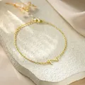 Detail view of a gold titanium steel chain bracelet with a letter Z charm - Letter Z Style / Gold