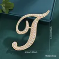 Vintage gold-toned letter T brooch pin featuring elegant pearl accents for clothing decor - Letter T