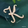 Large vintage style letter K brooch with white faux pearls on a golden metal finish - Letter K