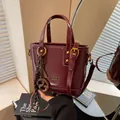 Vintage burgundy bucket bag with gold hardware and pretzel charm for women. - With Pendant / Red