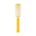 Vibrant yellow hair styling brush featuring a unique twisted handle and vented paddle design - Twisted Vented Hairbrush - Yellow