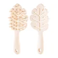 Ergonomic beige leaf-shaped hair massage brush with handle and durable silicone bristles - Ivory