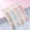 Pastel daisy print hair combs set of 4 with packaging on pink background - CJ03 Style (CJ03 Daisy)