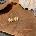 Elegant S925 silver needle asymmetric wave earrings with pearls for a refined look. - Wavy Border Artificial Pearl Style (E4985)