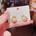 Elegant shell-shaped gold earrings featuring a central lustrous pearl design - Shell Artificial Pearl Stud Earrings (E4985) / One Pair / Gold