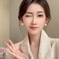 Elegant vintage gold textured dome earrings worn by a model in a beige blazer - Hammered Vintage Hemisphere Style (E4780) / Gold