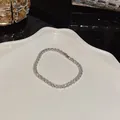 Silver-tone tennis bracelet with sparkling cubic zirconia on a white plate - Full Zirconia Tennis Chain Style (S210 Silver) / Silver