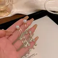 Elegant gold long tassel earrings featuring white pearls and sparkling rhinestones for women - Artificial Pearl Rhinestone Ball Tassel Style (E6029)