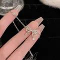 Elegant silver bow bracelet adorned with sparkling pavé-set cubic zirconia crystals - Full Zirconia Bowknot Tassel Style (S370 Silver) / Silver