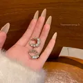 Elegant silver-toned small hoop earrings studded with sparkling crystals, held in hand - C-Shaped Pave Style (A1948银) / Silver
