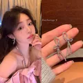 Close-up of elegant silver bow earrings with sparkling zircon stones on a model - Bowknot Tassel Earrings (A1424) / Silver