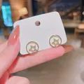 Elegant gold circular stud earrings featuring micro-inlaid sparkling star design - Five-Point Star in Round Frame Style (E3151)