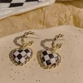Elegant gold heart earrings featuring a stylish black and white checkerboard pattern design - Checkerboard Heart Style (E4535)