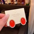 Elegant vintage red oval stud earrings with white pearl border presented on a jewelry card - Retro Oval Pearl Border Style (E4767)