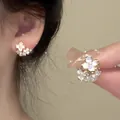 Elegant gold-tone flower stud earrings with pearl accents and minimalist design - Mother-of-Pearl Texture Floral Style / Gold White