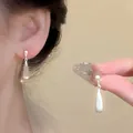 Elegant 925 silver needle teardrop earrings featuring a soft pearlescent moonstone glow. - Teardrop Cat Eye Stone Style (A2309) / Silver