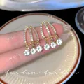 Elegant gold-finish geometric earrings with shimmering crystal tassels for stylish women. - Triple Geometric Crystal Tassel Style (E5953) / Gold