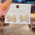 Elegant sparkling bow-shaped stud earrings with white pearls and 925 silver needles - Artificial Pearl Bowknot Style (E4240) / Gold