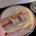 Elegant gold hoop earrings featuring delicate white pearl bow charms for a chic look - Bowknot Artificial Pearl Style (E5982) / 1 Pair Pack / Gold