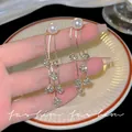 Elegant long tassel earrings with white pearls and sparkling rhinestone flower charms. - Rhinestone Flower Ball Tassel Drop Earrings (E6029) / One Pair / Gold