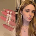 Exquisite pearl tassel drop earrings featuring silver chain fringe shown on a model - Single Pearl Multi-Chain Tassel Style (A1364 Silver)