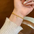 Elegant gold-plated bracelet featuring cz-inlaid flower charms on a delicate link chain. - Four-Leaf Flower Pendant Style (S689) / Gold
